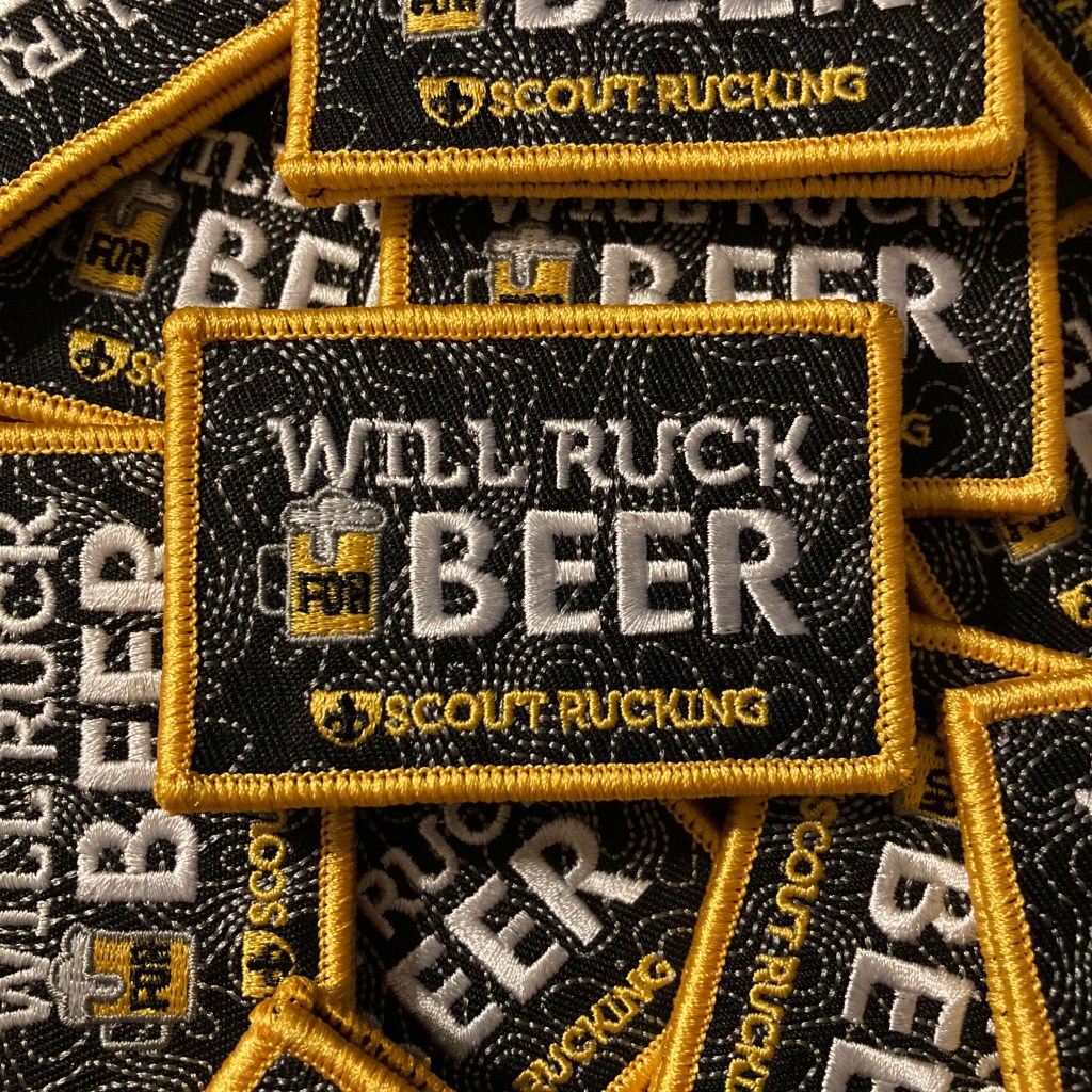Pile of embroidered tactical patches with the Scout Rucking logo and the words, "Will Ruck for Beer."