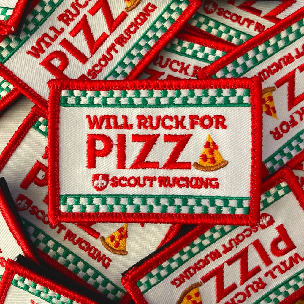 Pile of embroidered tactical patches with the Scout Rucking logo and the words, "Will Ruck for Pizza."